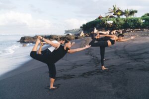 Gruppe beim Yoga an einem Strand auf Bali